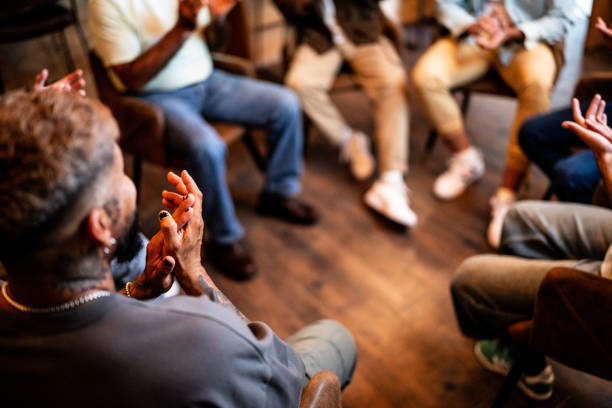 Men applauding in group therapy at mental health center